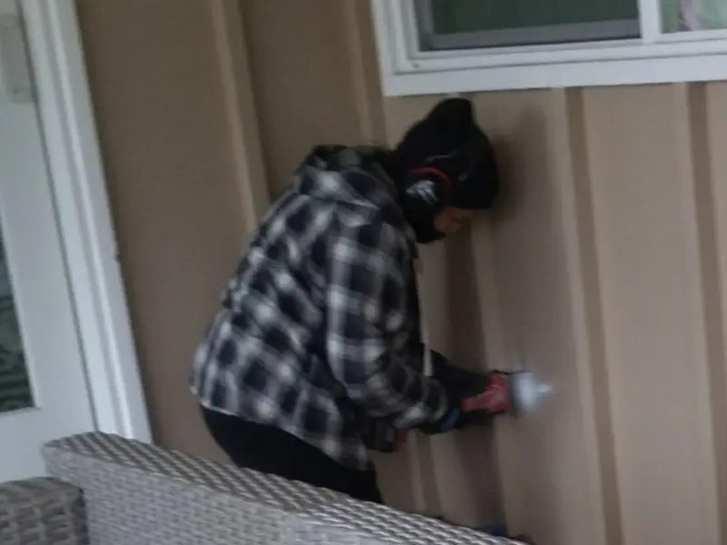 Professional electrician installing an exterior outlet in Carroll
