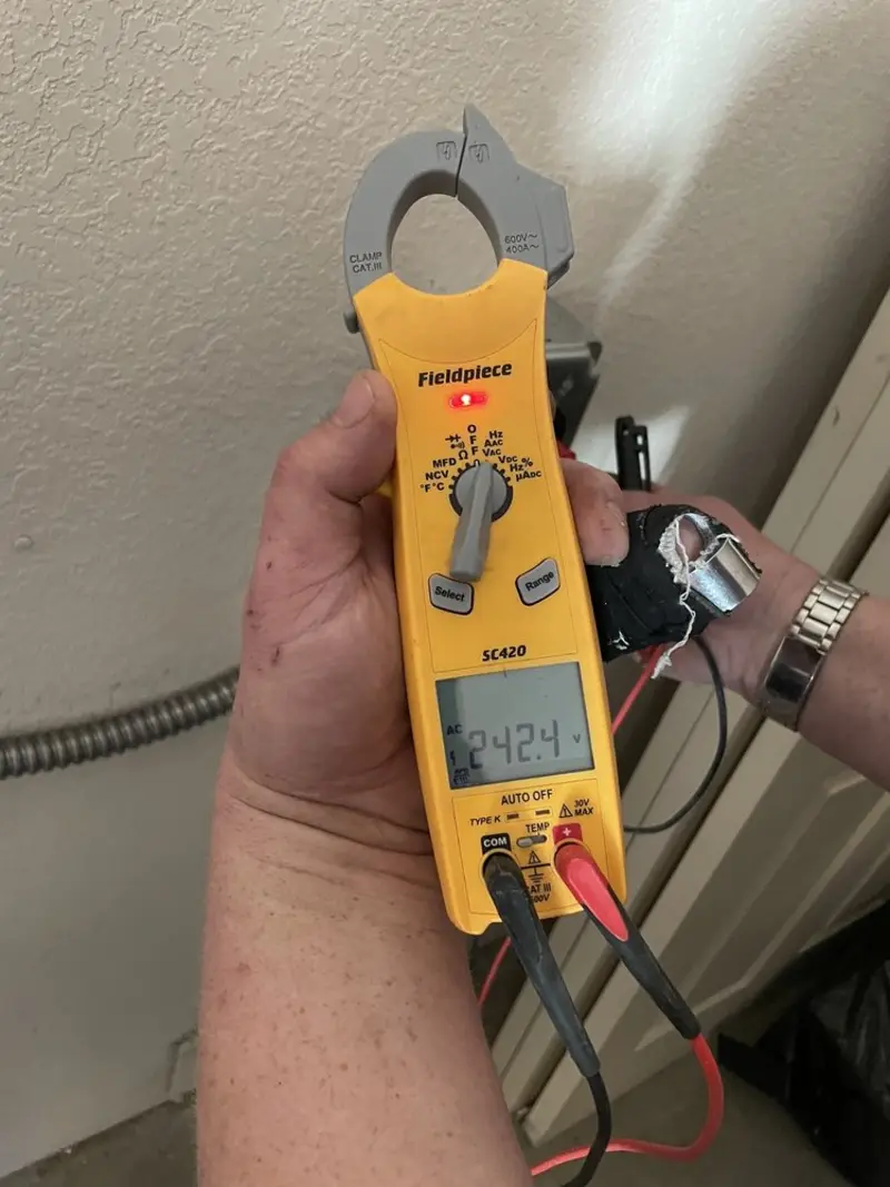 Voltage testing with clamp meter during Outlet Installation in Carroll